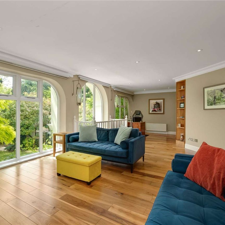 A spectacular three-bedroom home set within a private gated development, combining elegant period features with a dramatic double-height living space and south-facing garden. - Photo 1