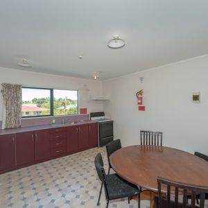 This furnished studio unit includes an ensuite bathroom and a small kitchenette. - Photo 3