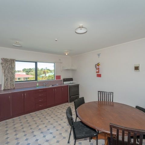 This furnished studio unit includes an ensuite bathroom and a small kitchenette. - Photo 1