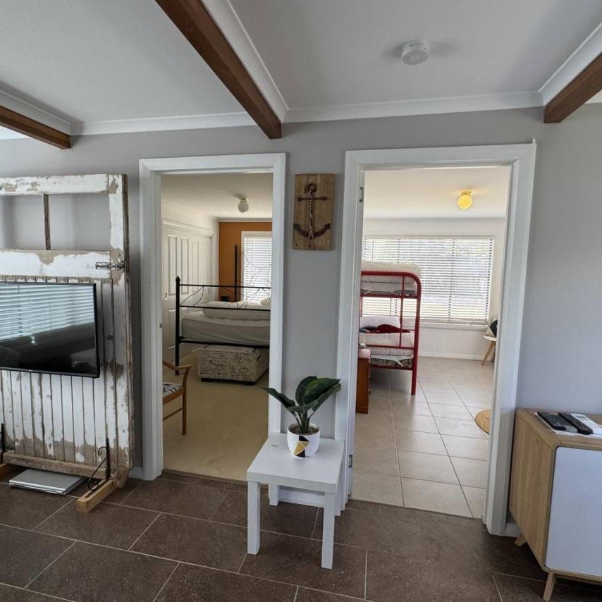 Live the Coastal Lifestyle – Furnished 4-Bedroom Retreat Steps from White Beach - Photo 1