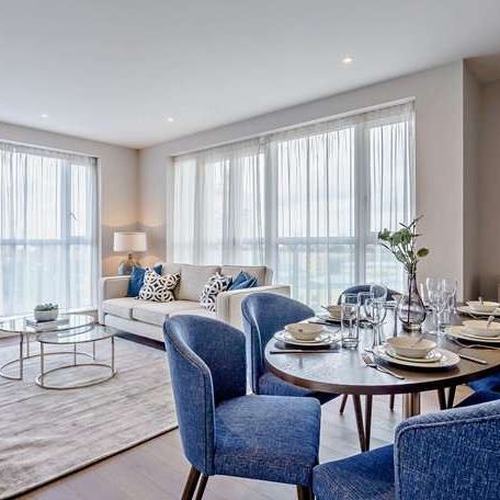 Luxury two-bedroom waterfront apartment with private balcony, stunning Canary Wharf views, premium amenities, and excellent transport links. - Photo 1