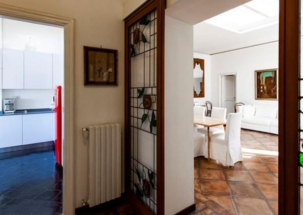 Attic-Monti: 1-6 month rentals. Spacious, furnished 3 Bedroom, 2 bath, living room, dining room, study and large panoramic terrace. Bright, silent, located in well kept Palazzo d’Epoca with elevator and doorman. Near transport and Metro.