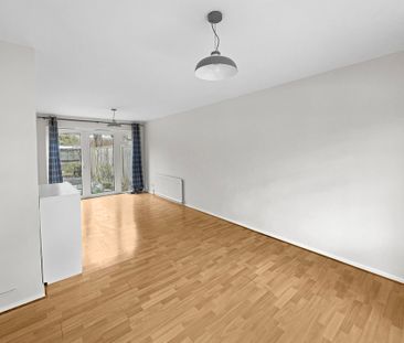 A three bedroom mid-terrace house with a private garden and a garag... - Photo 1