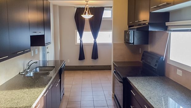 2 Bed Bankview Condo W/ Underground Parking | Heat & Water Included - Photo 1