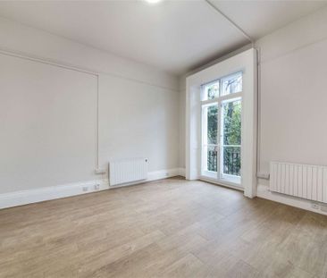 A self contained studio is on the ground floor of a white stucco fr... - Photo 3