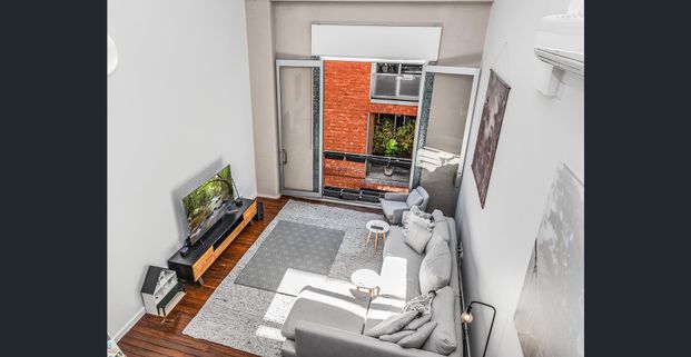 Top-Floor Loft Living with Timeless Industrial Charm - Photo 1