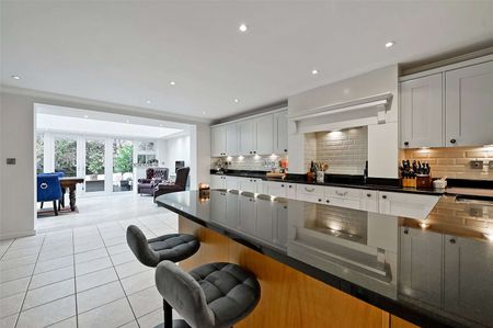 A spacious and impressive town house with ground floor rear extension in this sought after development. - Photo 2