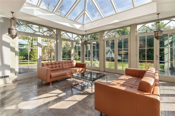 Exceptional gated residence extending to approximately 8,200 sq ft, set within mature landscaped grounds of over half an acre. - Photo 1