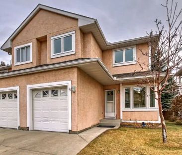 Beautiful 2 Storey Townhouse 3+1 Bedrm + 3.5 Bath Sandstone NW Calgary | 388 Sandarac Drive Northwest, Calgary - Photo 1