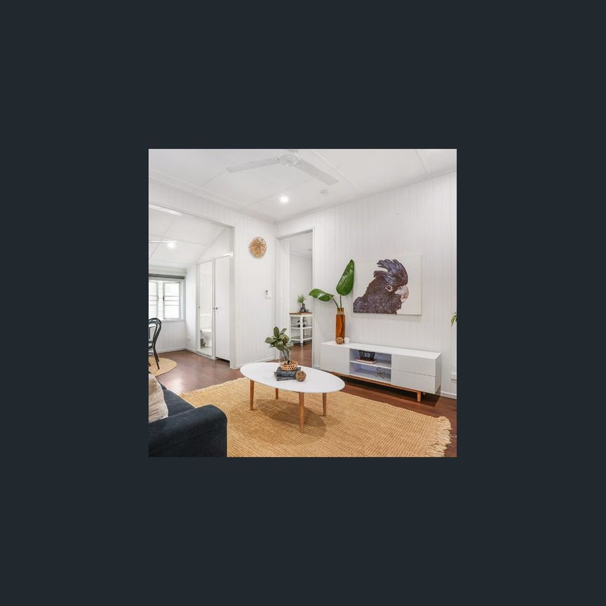 Charming home with light filled living - Photo 1