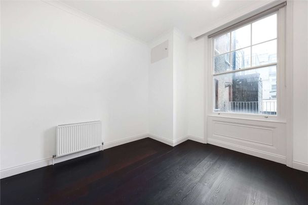 A first floor one bedroom apartment in a recently refurbished building benefitting from a generous reception room with 3.5m high ceilings, lift access and wooden flooring throughout. - Photo 1