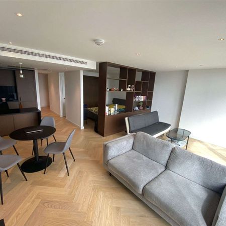 This exquisite apartment boasts breath-taking views of the River Thames from floor-to-ceiling windows. It comprises a spacious open-plan reception, kitchen, and living area. - Photo 4