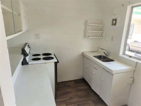 A two-bedroom, one-bathroom unit offering a generous open-plan living area, kitchen, laundry, and bathroom. - Photo 5