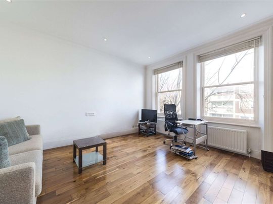 This is a charming two double bedroom property on a popular residential road in Baron's Court. - Photo 1