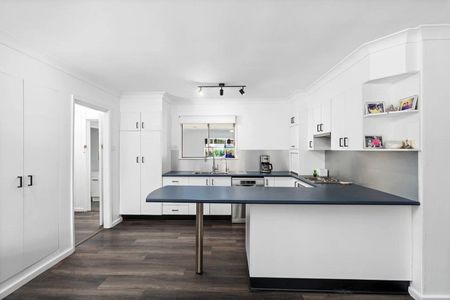 Family home with multiple living zones and large fenced yard - Photo 5