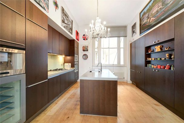 Located in the heart of South Kensington a striking three bedroom period conversion with own entrance, a vast reception room boasting double height ceilings and wooden floors. - Photo 1