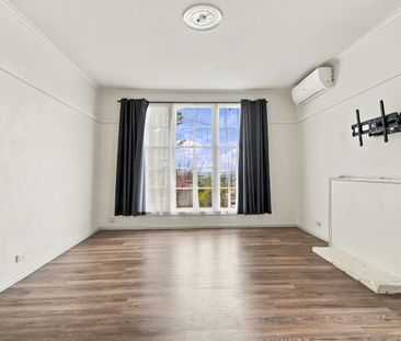 Three-Bedroom Home with Fresh Flooring and Spacious Backyard - Photo 1