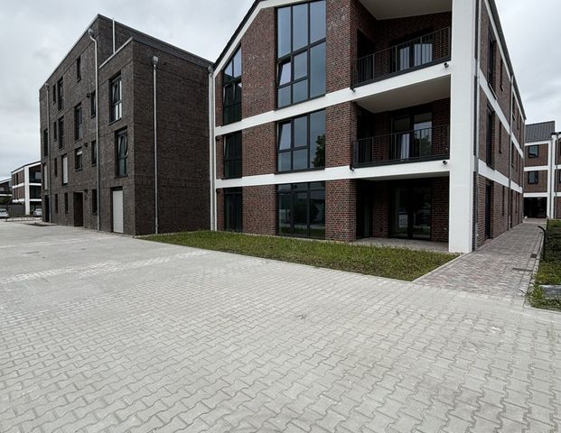 Wohnen am Norder Tief: Schöne Erdgeschosswohnung mit Blick auf die Mühle! ERSTBEZUG - Foto 1
