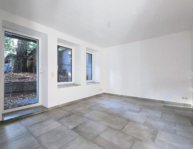 Gemütliche Souterrain-Wohnung mit Terrasse, Einbauküche und Fußbodenheizung - Photo 1