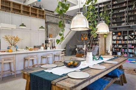 A unique 3,500 sq ft penthouse in a Grade II listed Victorian factory conversion, combining modern open-plan living with original industrial character. - Photo 3