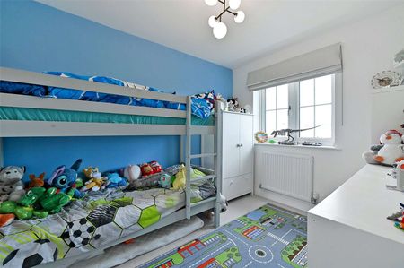 Situated in a peaceful location with open green space to the front, this spacious family home is arranged over three floors and offers well-presented accommodation throughout. - Photo 4