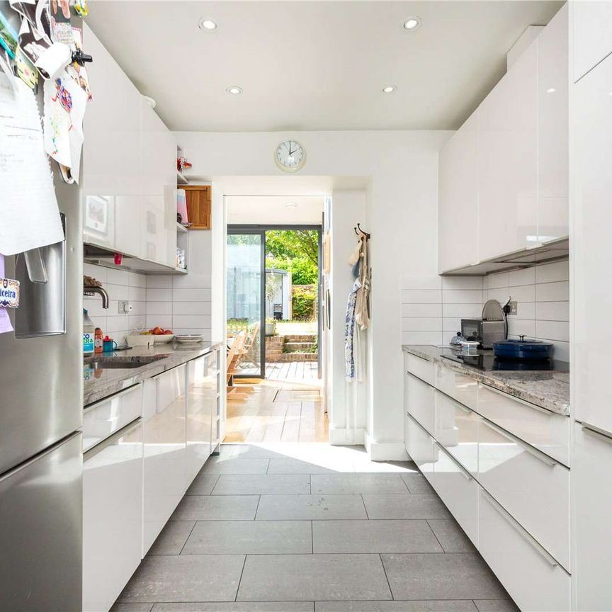 A beautifully presented three bedroom house with large west facing garden in a fantastic Islington location just moments from Highbury & Islington station. - Photo 1