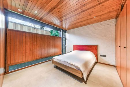 Nestled within a prestigious secluded private road in Blackheath, this striking family home stands as a testament to contemporary luxury and sustainability. Spanning 1197 square feet. - Photo 4