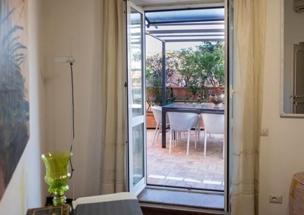 Attic-Monti: 1-6 month rentals. Spacious, furnished 3 Bedroom, 2 bath, living room, dining room, study and large panoramic terrace. Bright, silent, located in well kept Palazzo d’Epoca with elevator and doorman. Near transport and Metro.