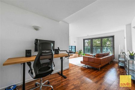 Available Now & Part Furnished, A beautifully presented two-bedroom apartment located on the first floor of the prestigious riverside development, New Providence Wharf. - Photo 2