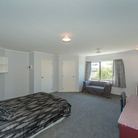 This furnished studio unit includes an ensuite bathroom and a small kitchenette. - Photo 1