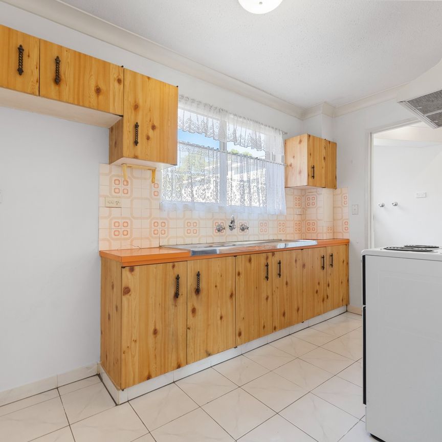 First-Floor Full Brick Two-Bedroom Unit with Single Garage! - Photo 1