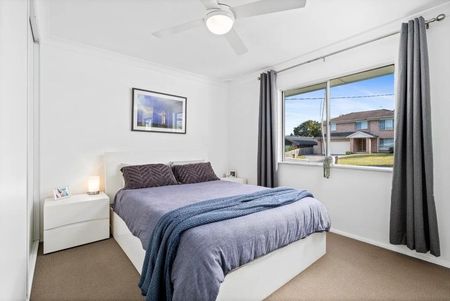 Family home with multiple living zones and large fenced yard - Photo 3