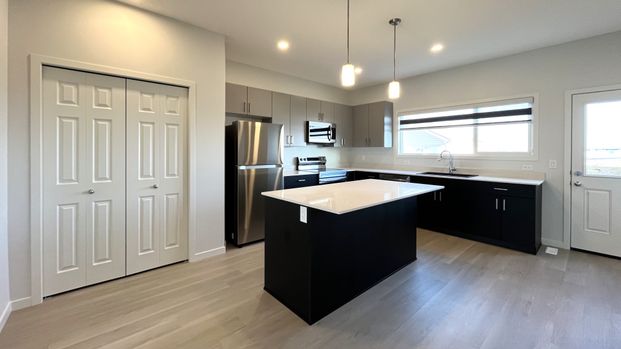 Modern 3 Bed Main Floor With In Suite Laundry - Photo 1