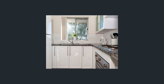 Located at the back of the block offering extra privacy, this two bedroom unit is bright & spacious with convenience at your door step! - Photo 1