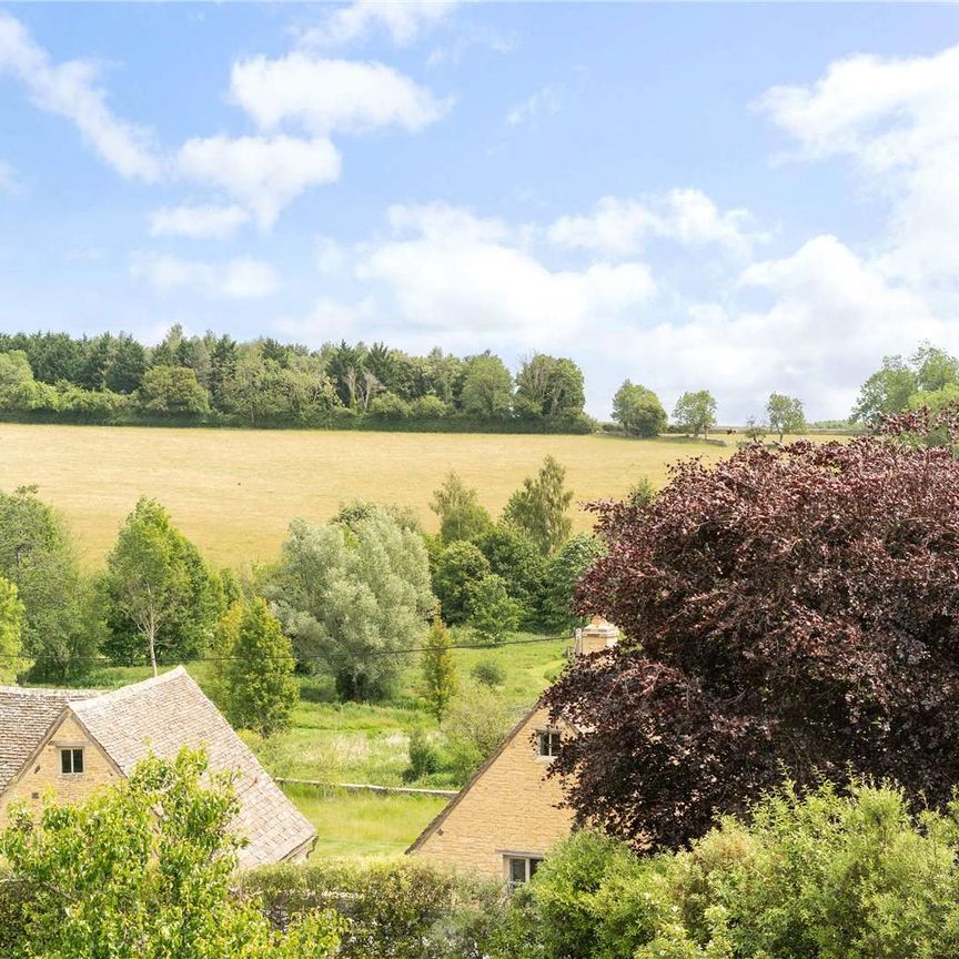 A stunning Grade II-listed barn conversion with beautifully imagined, high specification interiors, in the heart of an idyllic Cotswolds village - Photo 1
