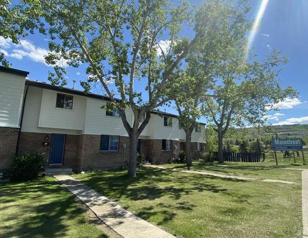 Bow River Townhomes | 6347 Bowview Road NW, Calgary - Photo 1