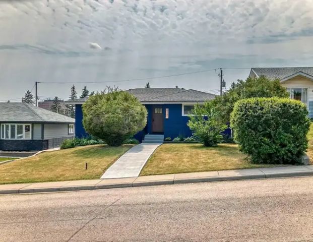 Beautifully Renovated Home with Ideal Access to Train, Schools, and City Center | 615 101 Avenue Southwest, Calgary - Photo 1