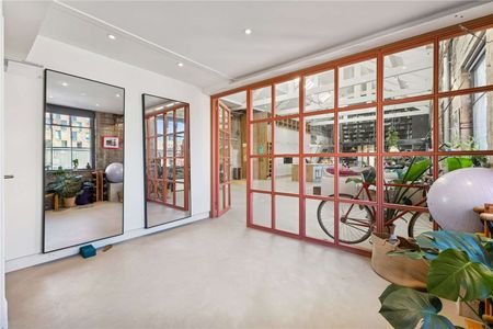 A unique 3,500 sq ft penthouse in a Grade II listed Victorian factory conversion, combining modern open-plan living with original industrial character. - Photo 4