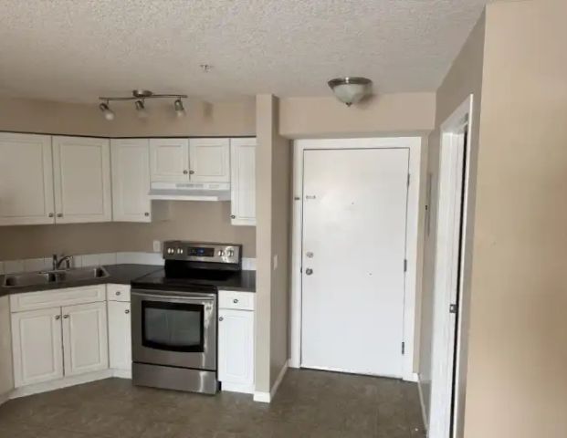 2nd floor condo unit with deck and underground parking | 203 - 2000 Applevillage Court Southeast, Calgary - Photo 1
