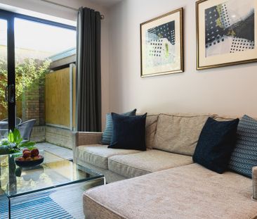 A fully furnished, one-bedroom apartment with a private balcony and... - Photo 1