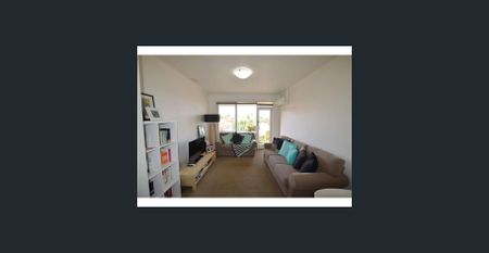 This secure residence offers low-maintenance living with a light-filled interior and practical design - Photo 4