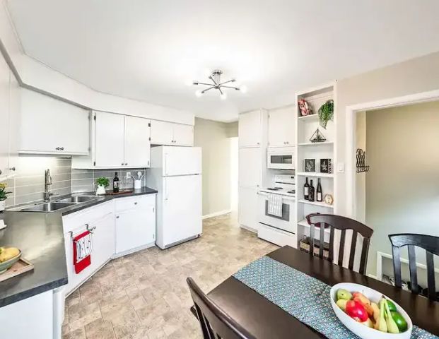 Bright, Updated Kingsland Bungalow | 712 Heritage Dr SW, Calgary - Photo 1