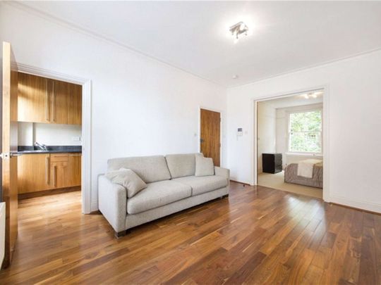 A modern first floor one bedroom apartment with wooden floors in the reception room. - Photo 1