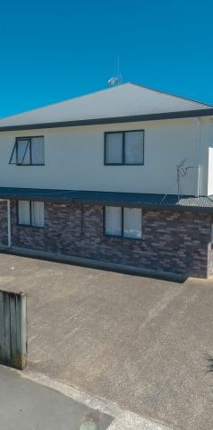 This furnished studio unit includes an ensuite bathroom and a small kitchenette. - Photo 1