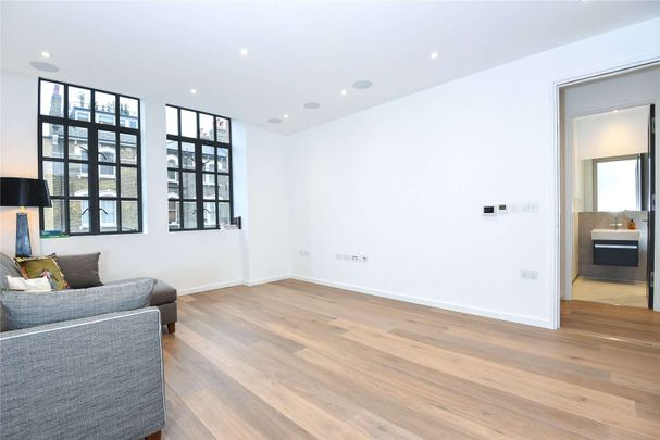 Set on the first floor of The Maple Building, is this modern one-bedroom apartment. - Photo 1