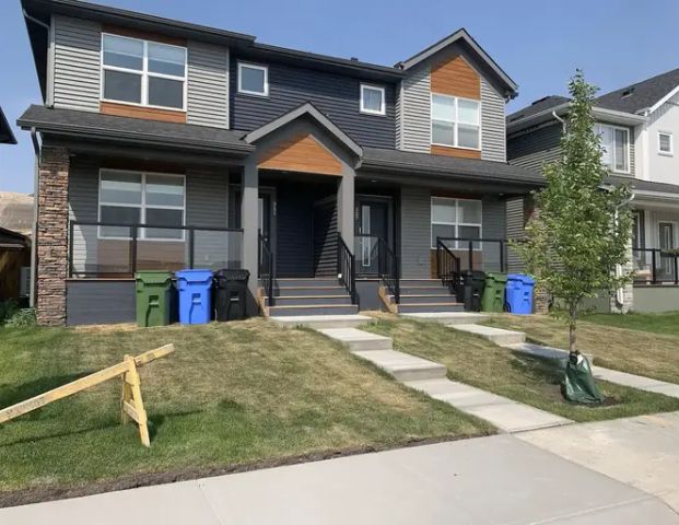 Duplex near walking and biking trails, dog park and golf course | 311 Wolf Creek Way Southeast, Calgary - Photo 1