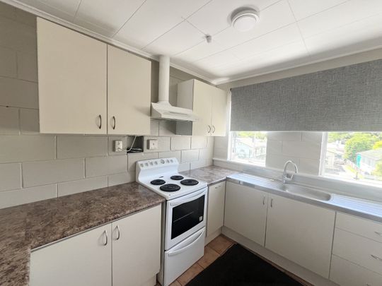 Step into comfort and convenience with this upstairs unit, freshly updated with brand new carpet throughout. - Photo 1