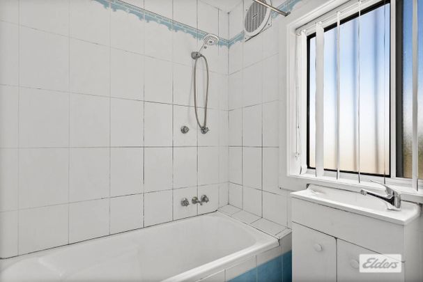 Neat & Tidy Family Home | Split-Level Living in Prime Location - Photo 1