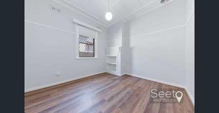 A full brick character home brimming with original charm, offering three spacious bedrooms. - Photo 3