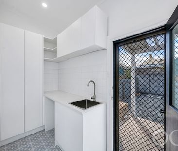 Open the Door to Coastal Charm with Modern Comfort - Photo 4
